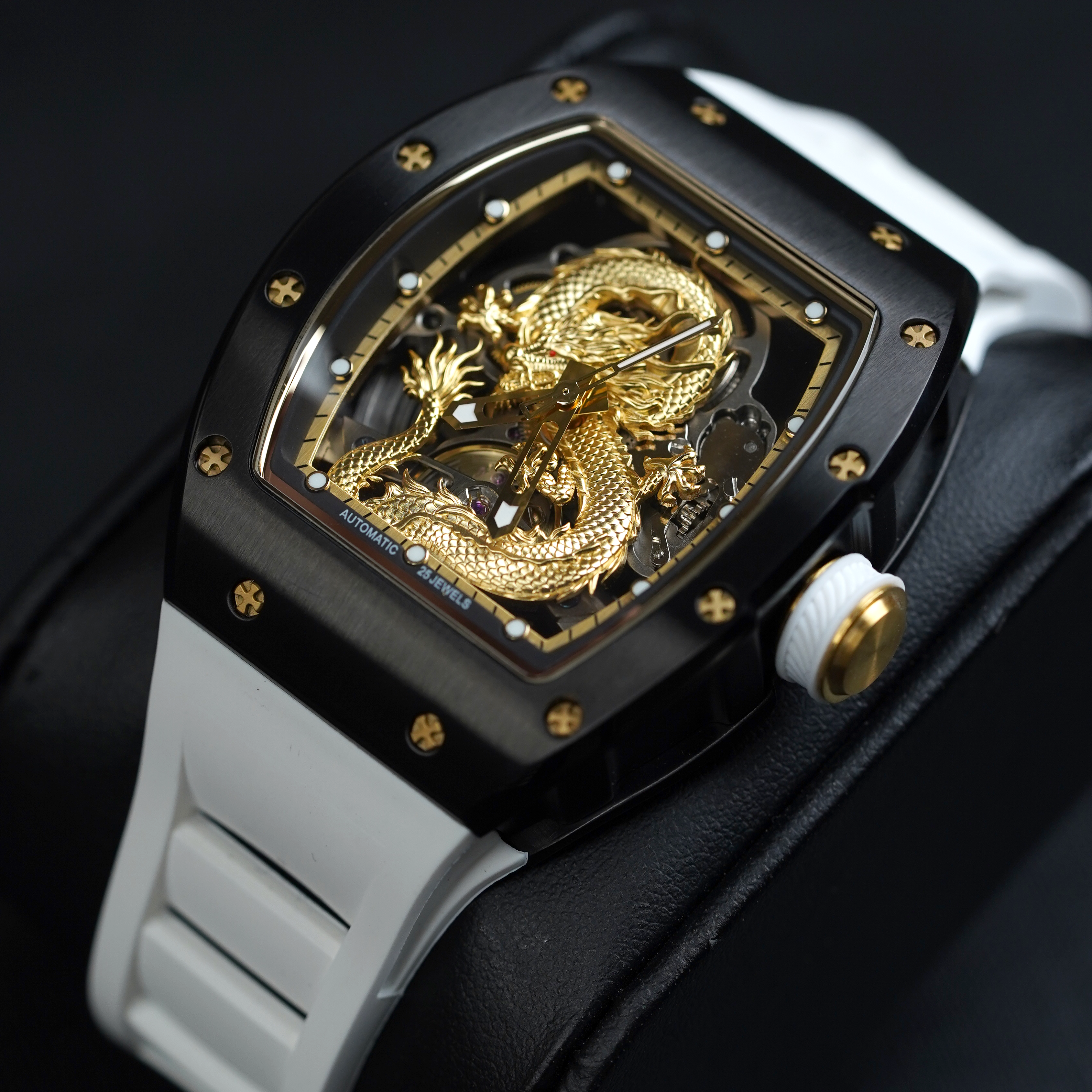 Luxury racing-inspired watch with gold dragon dial, black case, and white strap