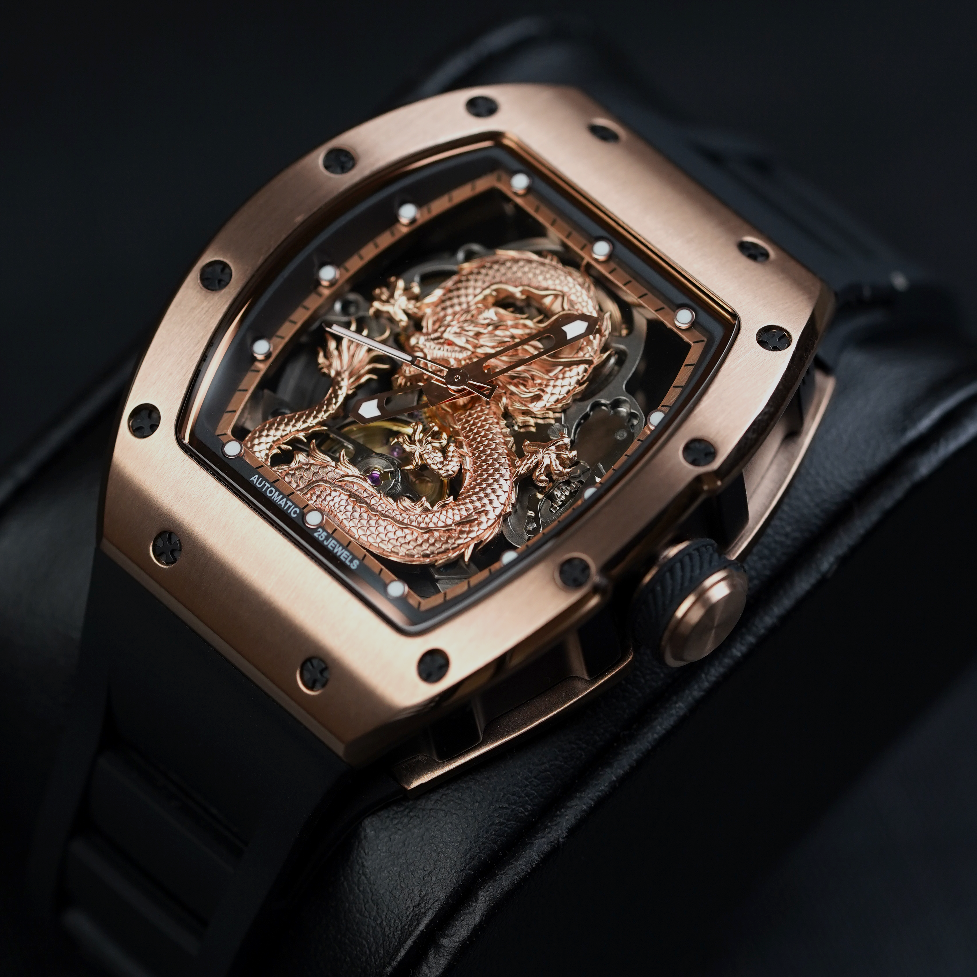Luxury skeleton sport watch with rose gold case, dragon motif, black rubber strap, bold design
