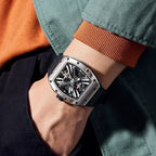 Luxury motorsport-inspired tonneau watch with skeleton dial and bold black strap on wrist