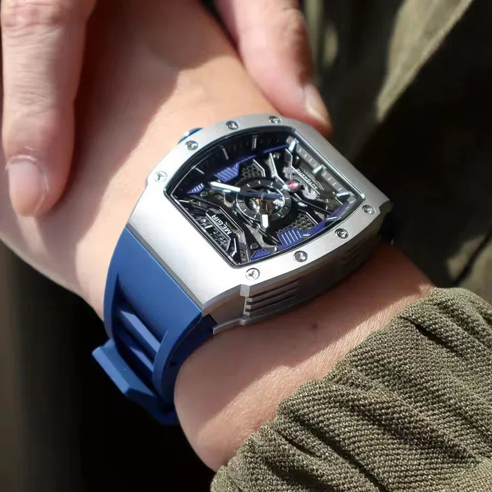Motorsport-inspired skeleton watch with blue strap and bold tonneau case on wrist