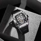 Skeleton dial luxury sport watch with skull motif, tonneau case, and black rubber strap