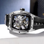 Racing-inspired skeleton dial automatic watch with tonneau case and black rubber strap