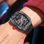 Carbon fiber skeleton watch with bold motorsport design, red crown, and sport-luxury style on wrist