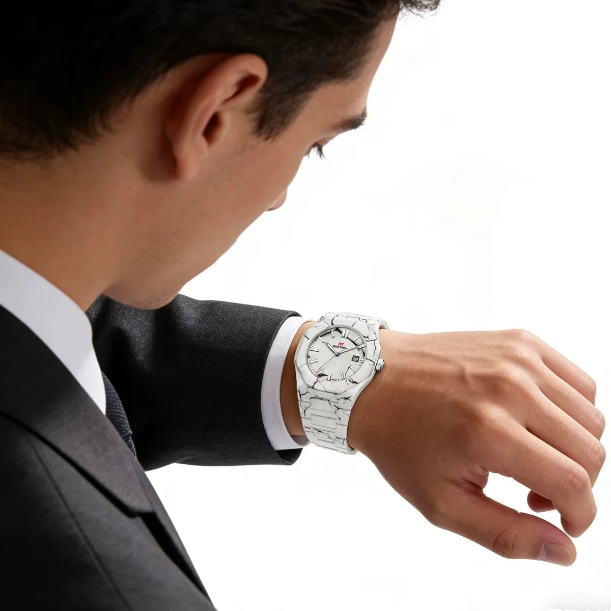 Man in suit wearing marble-patterned luxury watch with bold, racing-inspired design