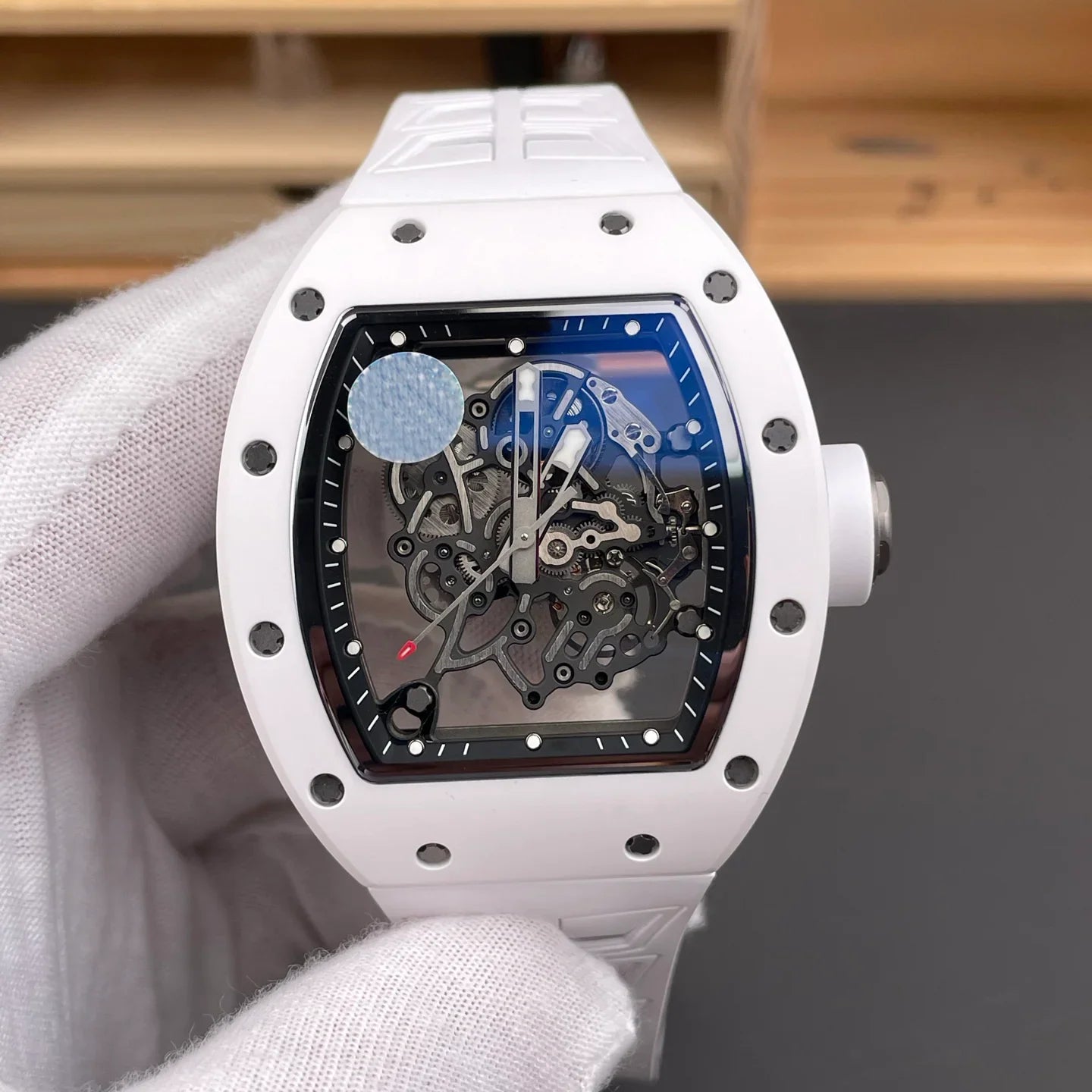 White tonneau skeleton watch with exposed gears, motorsport-inspired luxury design