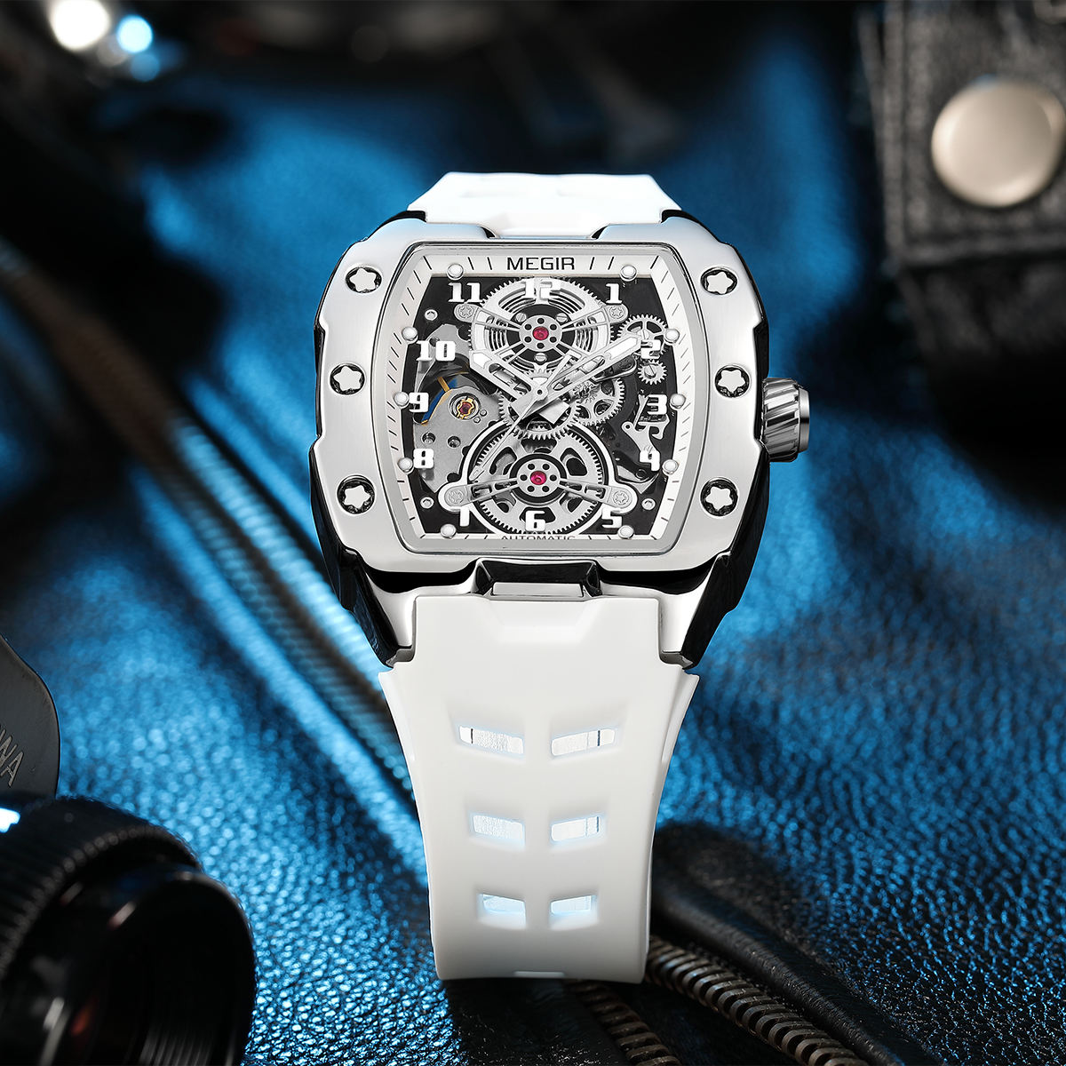 Racing-inspired skeleton dial watch with a square case, white strap, and sport-luxury design