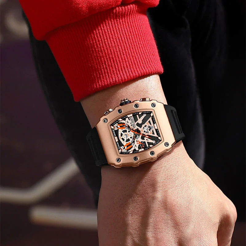 Luxury motorsport-inspired watch with rose gold case, skeleton dial, black strap on wrist