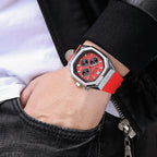 Motorsport-inspired red chronograph watch with hexagonal case and sporty red strap on wrist