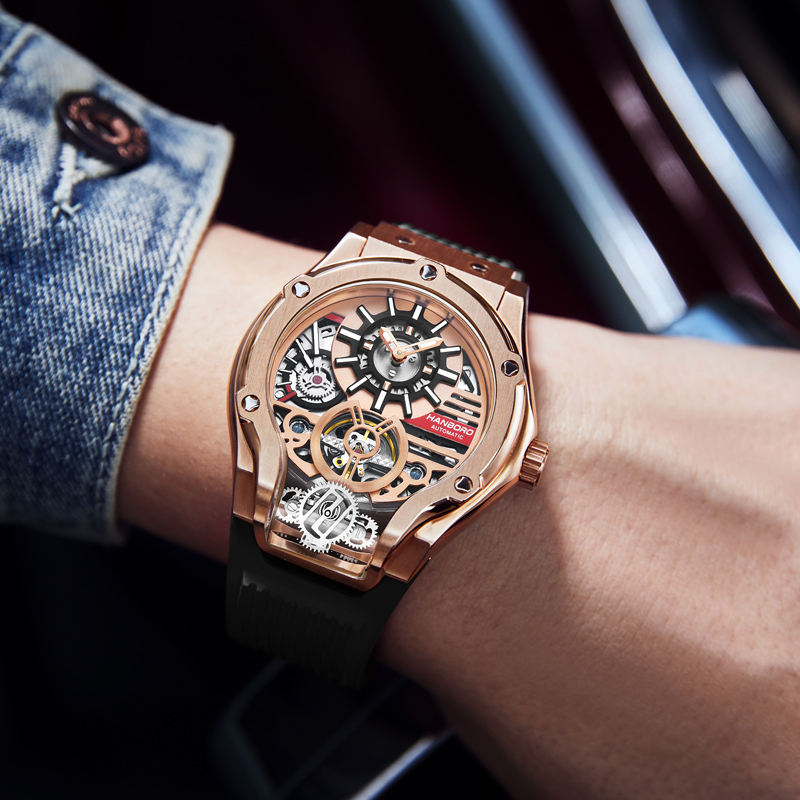 Luxury motorsport-inspired skeleton watch with rose gold case and black strap on wrist