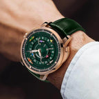 Luxury motorsport-inspired watch with green dial, rose gold case, and racing miniatures on wrist
