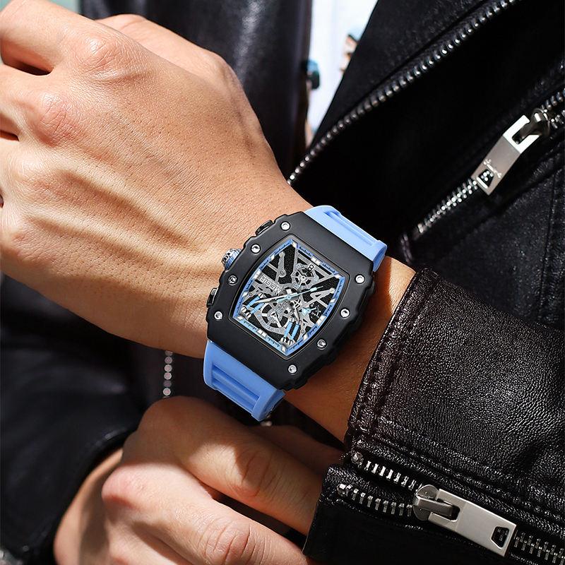 Motorsport-inspired skeleton watch with blue strap, worn with leather jacket, luxury sport style