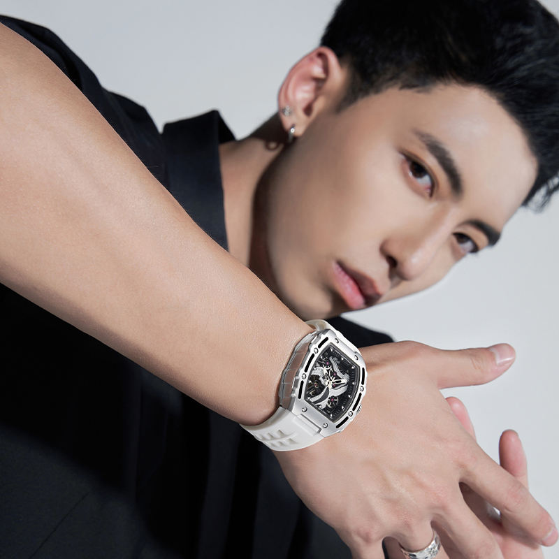 Man wearing a bold motorsport-inspired sport-luxury watch with white strap and skeleton dial