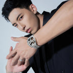 Man wearing a motorsport-inspired skeleton luxury watch with silver metal band
