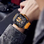 Motorsport-inspired luxury watch with orange strap and skeleton dial on wrist