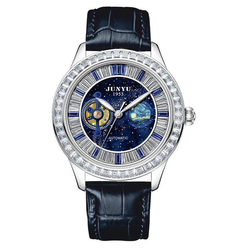 Luxury automatic watch with blue cosmic dial, crystal bezel, and black leather strap