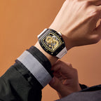 Luxury sport-inspired watch with gold dragon skeleton dial, white strap, worn on wrist