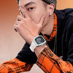 Man wearing a white strap sport-luxury skeleton chronograph watch with racing-inspired design