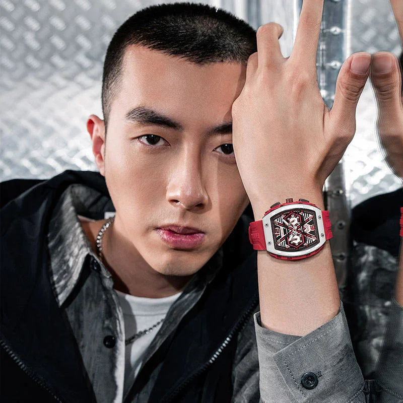 Man wearing motorsport-inspired luxury watch with bold red strap and modern skeleton dial