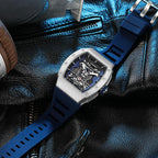 Luxury motorsport-inspired watch with blue strap and skeleton dial on black leather
